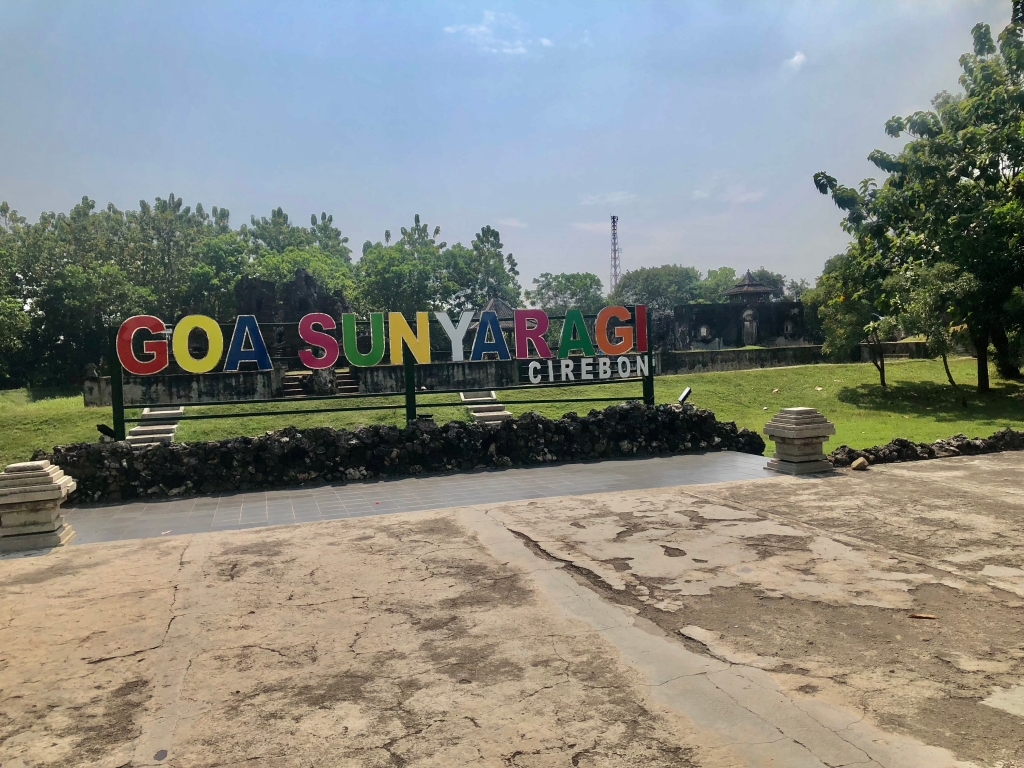 The welcoming stage for tourist to take a picture with a "Goa Sunyaragi Cirebon" text behind and the Gua Sunyaragi it self at background.